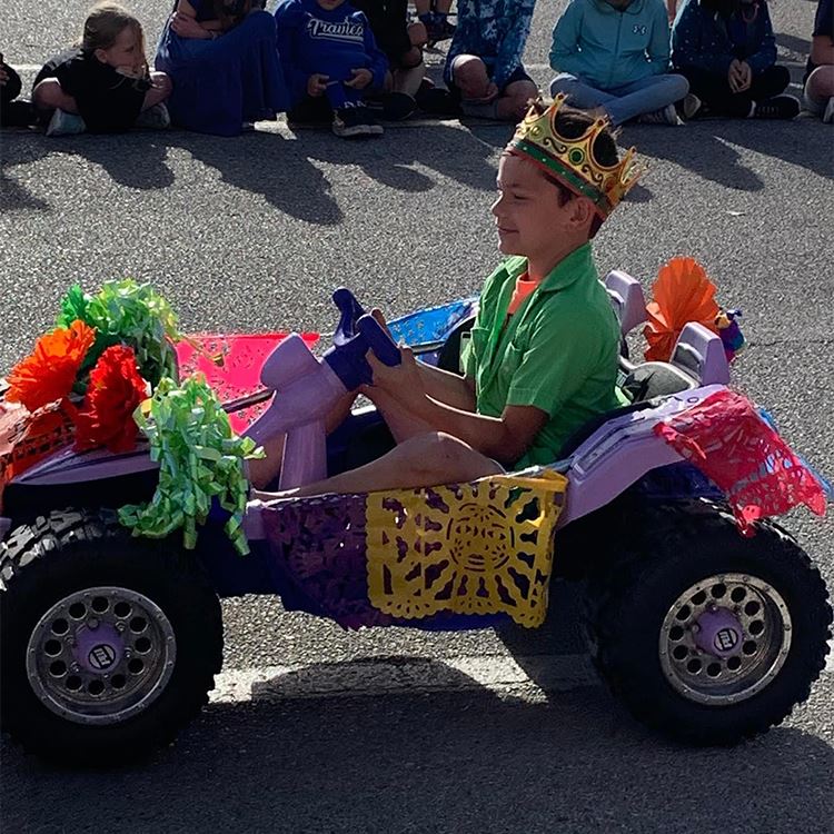 Student in a car smiling
