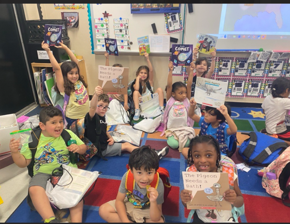 Children holding up books